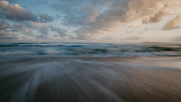 Warm golden sunset over the beach at Keurboomstrand near Plettenberg Bay