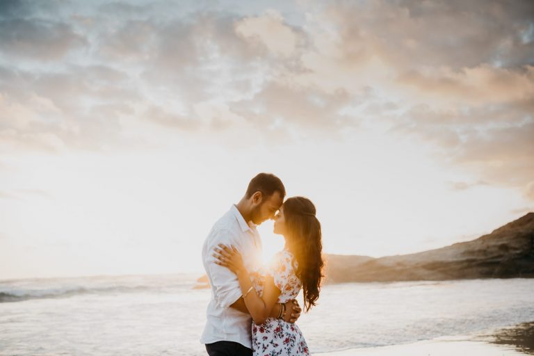 Couple reacting with joy during a surprise engagement at Robberg Nature Reserve