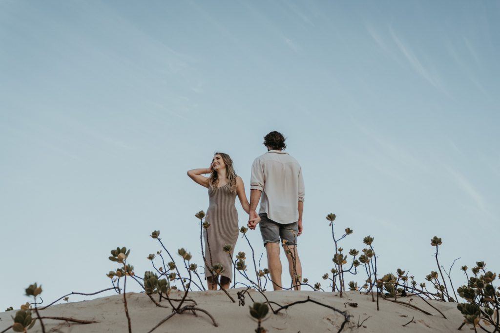 couple leaning into each other on the shoreline at keurboomstrand