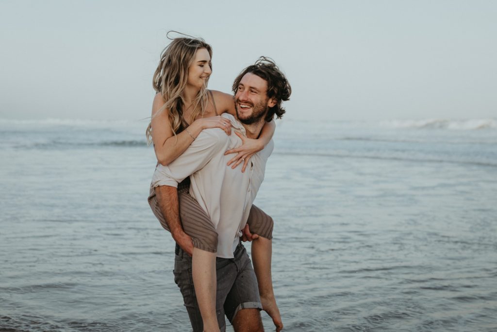 couple sharing a quiet moment together on keurboomstrand beach