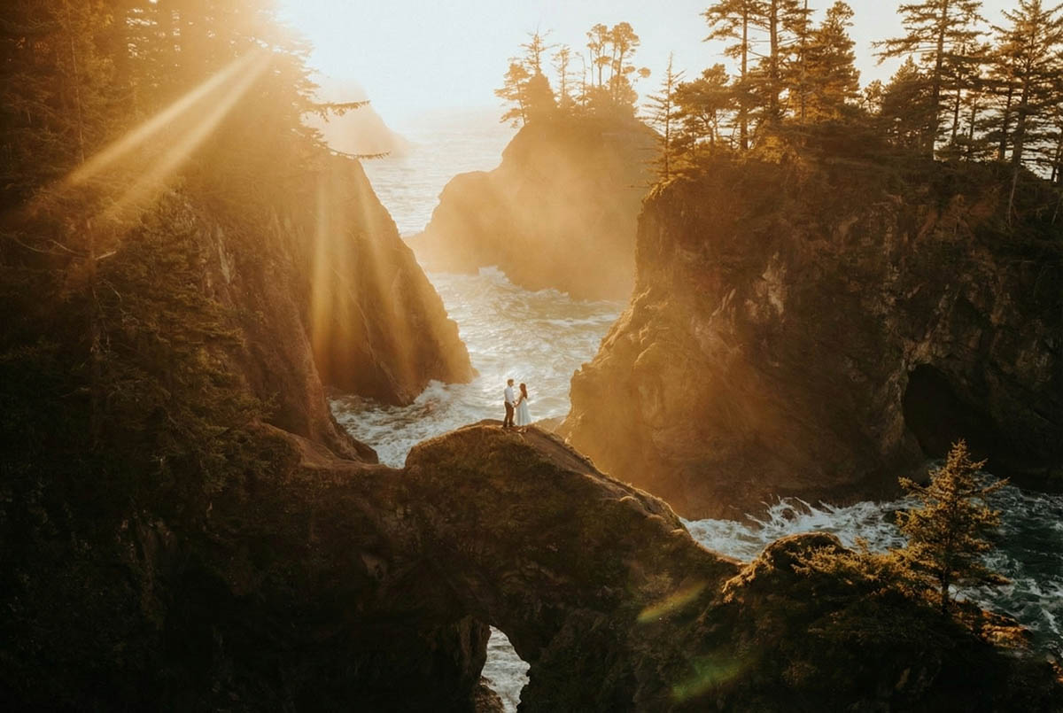 eloping couple walking through a misty oregon landscape