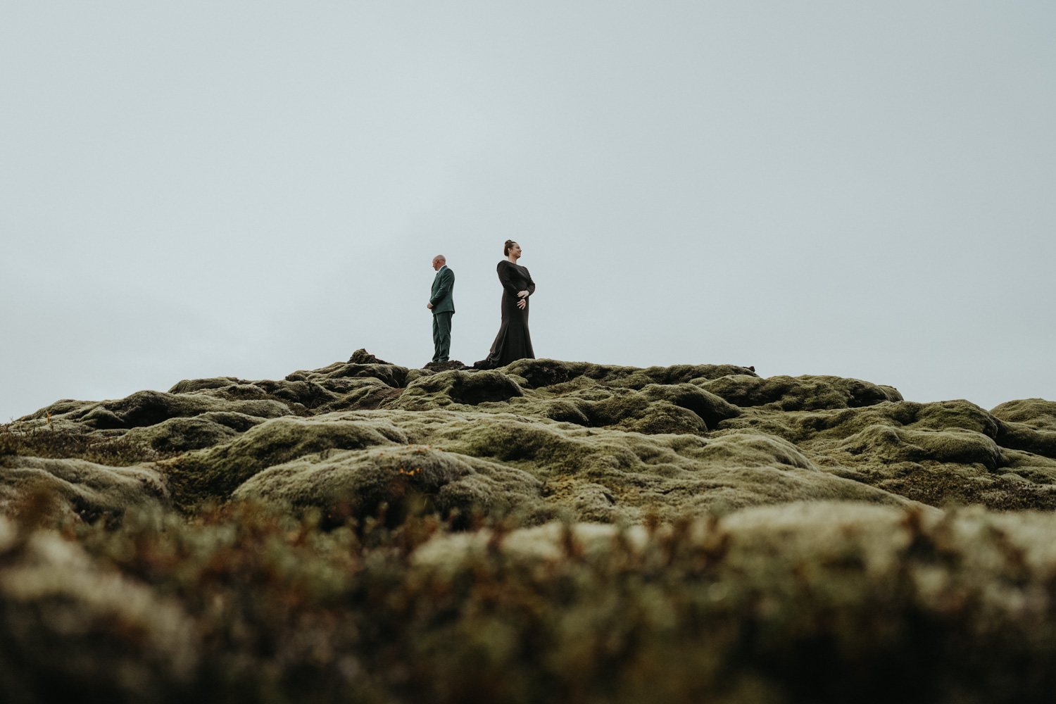 couple walking together through an expansive icelandic landscape early in their elopement