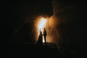 Home Updated 33 wedding and elopement photographer couple wrapped together in the open icelandic landscape during their elopement